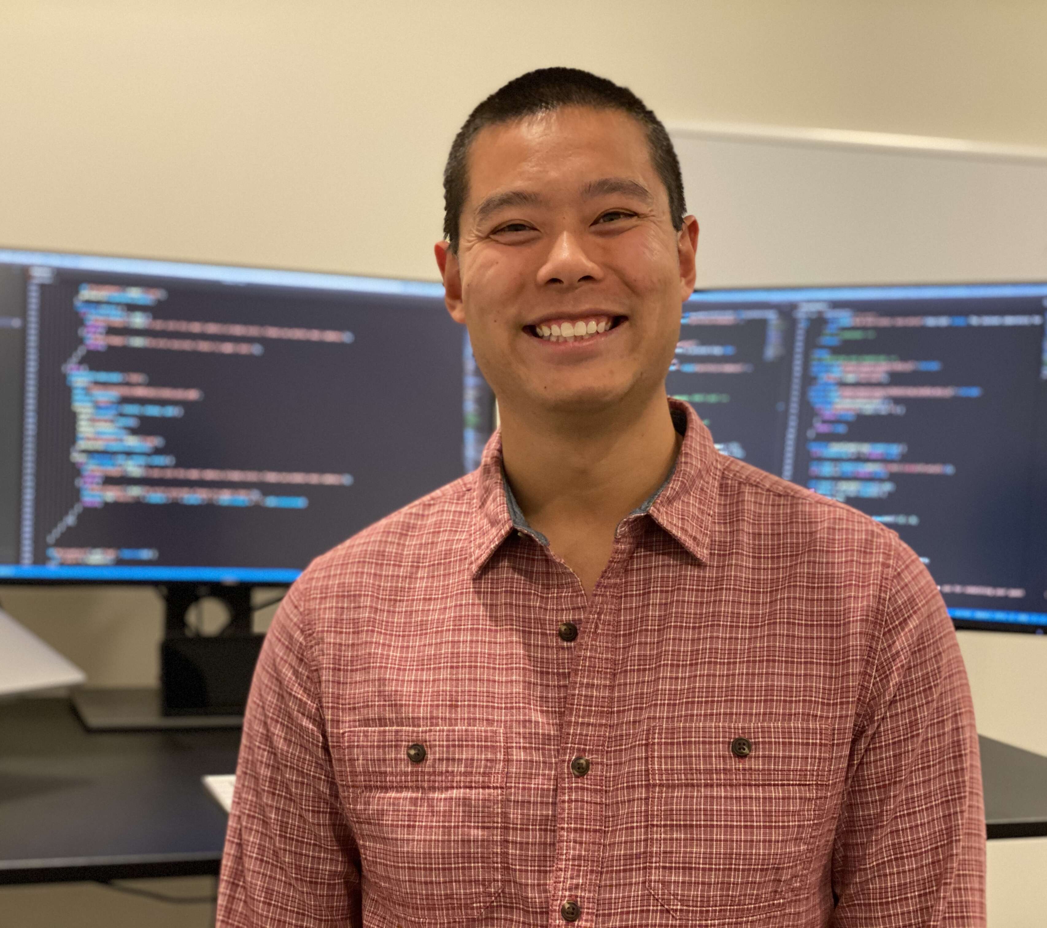 Image of Matt in front of computer monitors